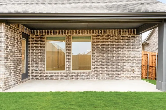 a view of front door of a house with a yard