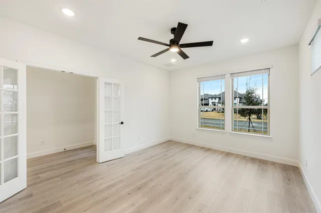 a view of a livingroom with a ceiling fan and window