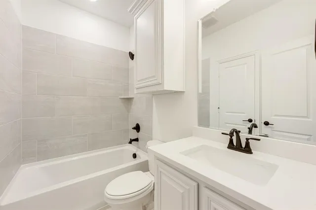 a bathroom with a sink a toilet and a bathtub