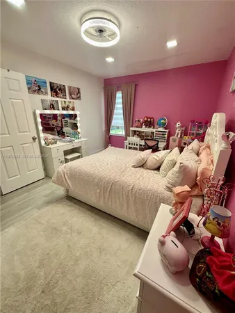 a bedroom with furniture and a large window