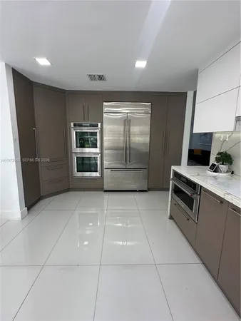 a kitchen with stainless steel appliances granite countertop a stove and a refrigerator