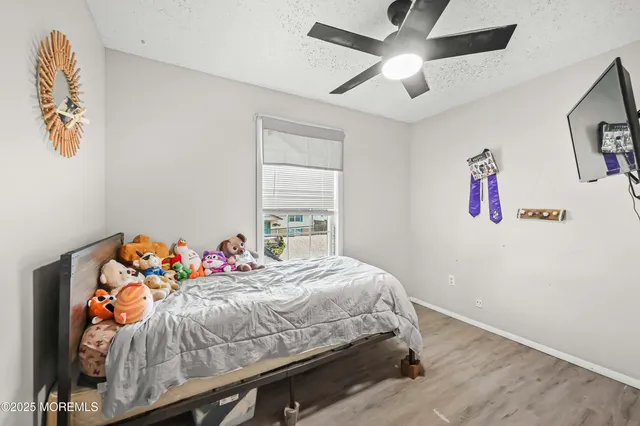 a bedroom with a bed and a chandelier