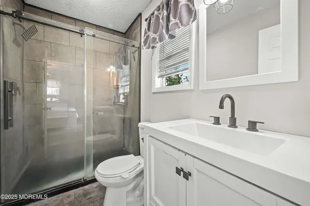 a bathroom with a sink toilet and shower