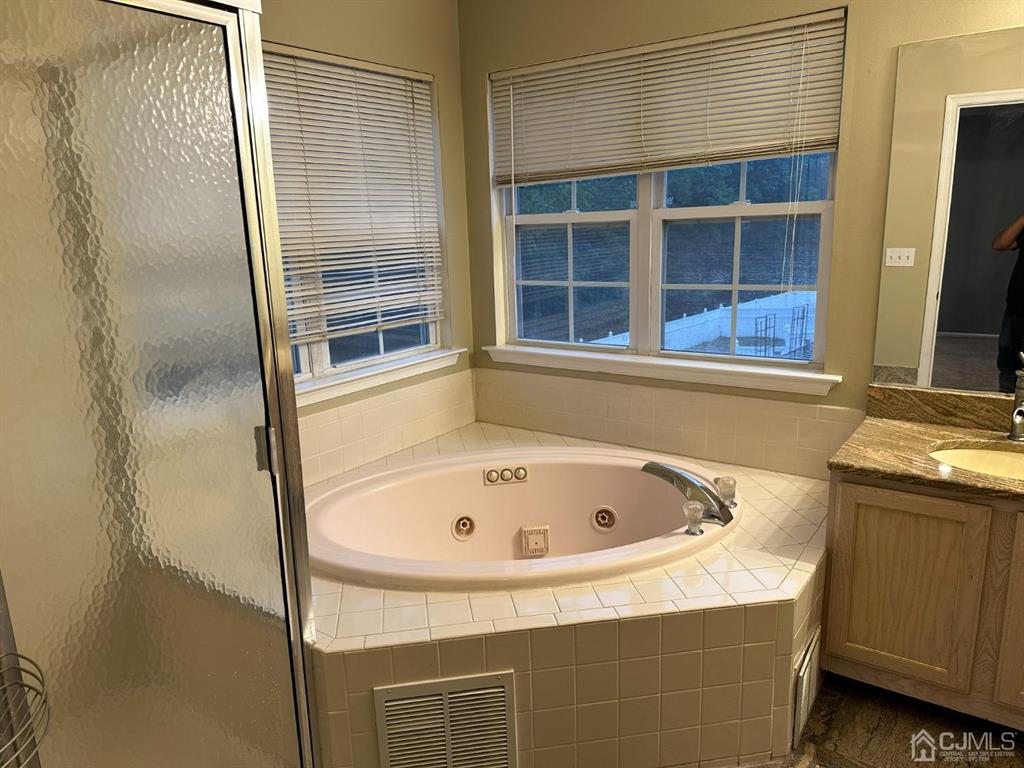 58 Timber Ridge Road North Brunswick, NJ 08902 - Photo 5 of 8 a bathroom with a tub and a shower