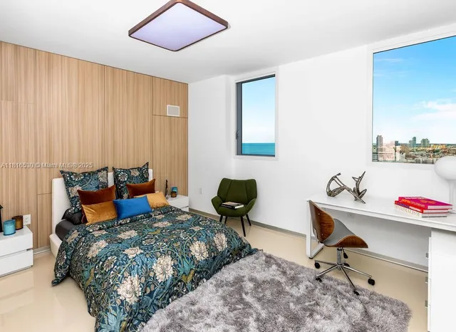 a bedroom with a bed and chair