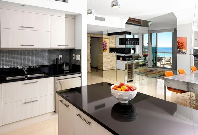 a kitchen with stainless steel appliances kitchen island granite countertop a sink and cabinets
