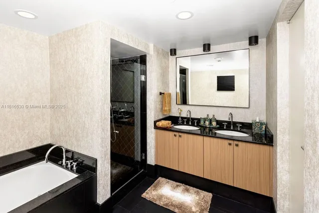 a bathroom with a sink a mirror and a shower