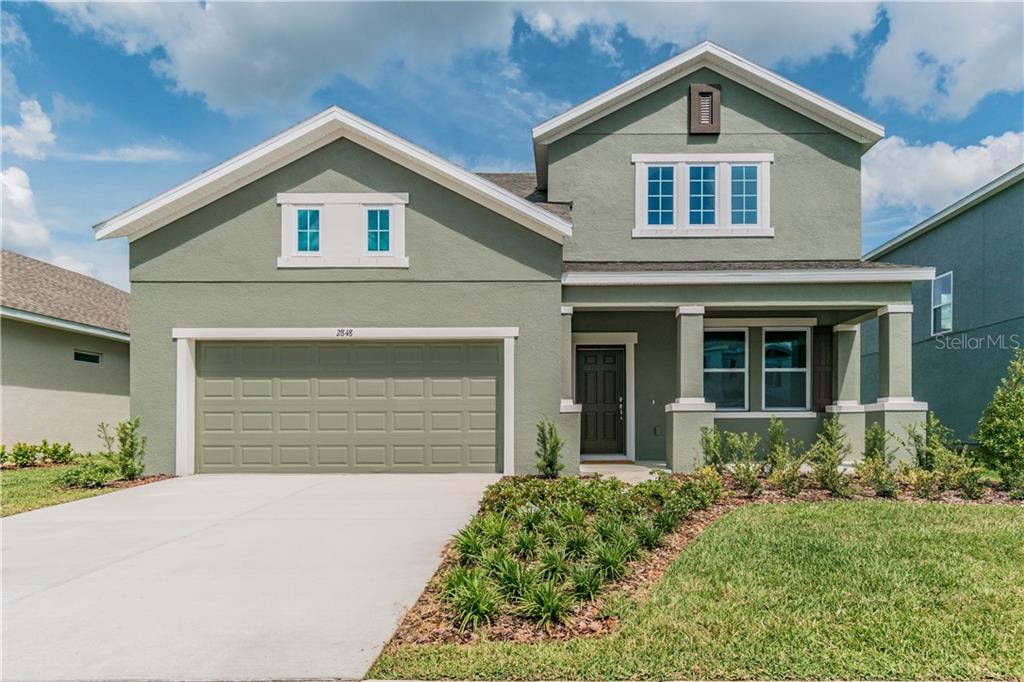2848 Satilla Loop Odessa, FL 33556 - Photo 1 of 1 a front view of a house with a yard and garage