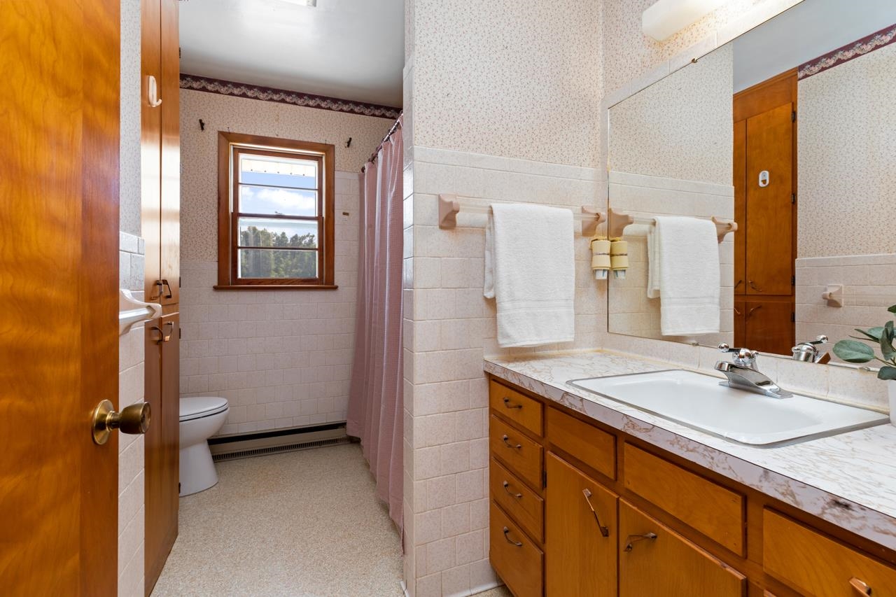 3252 Lyndhurst Road Stuarts Draft, VA 24477 - Photo 25 of 75 a bathroom with a granite countertop sink a mirror and a shower