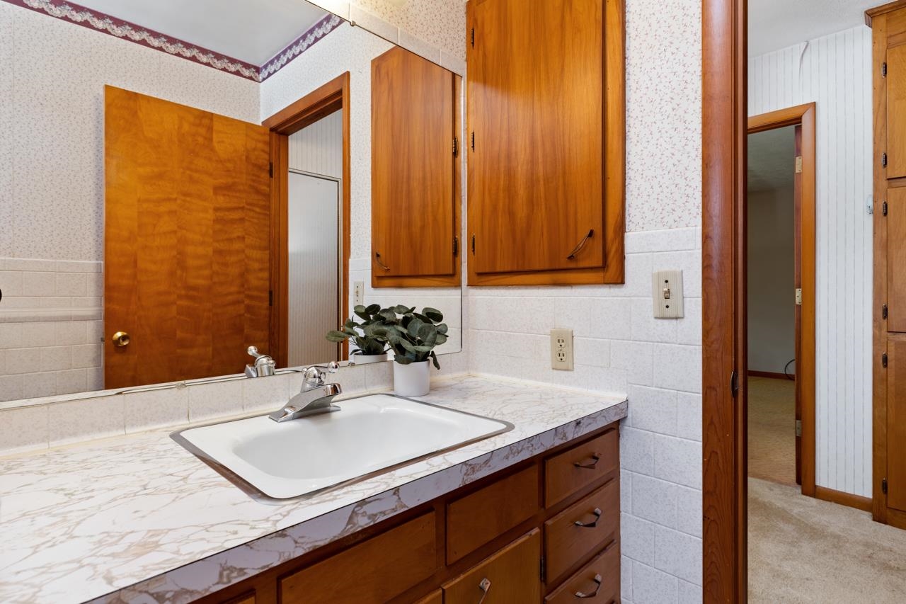 3252 Lyndhurst Road Stuarts Draft, VA 24477 - Photo 26 of 75 a bathroom with a sink and a mirror