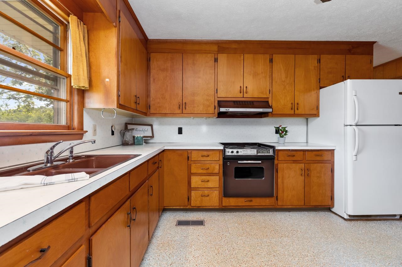 3252 Lyndhurst Road Stuarts Draft, VA 24477 - Photo 5 of 75 a kitchen with granite countertop a sink and a refrigerator