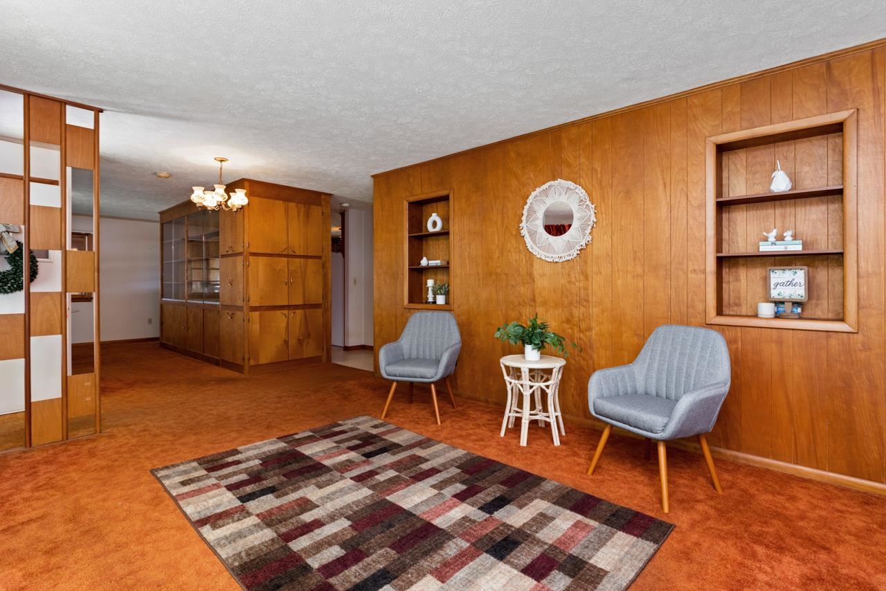 3252 Lyndhurst Road Stuarts Draft, VA 24477 - Photo 10 of 75 a living room with a couch and a bookshelf with wooden floor