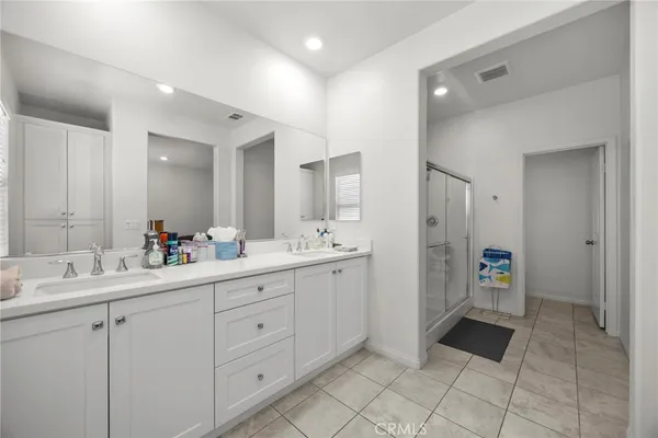 a bathroom with a sink double vanity and a mirror