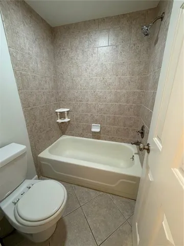 a bathroom with a toilet and a bathtub