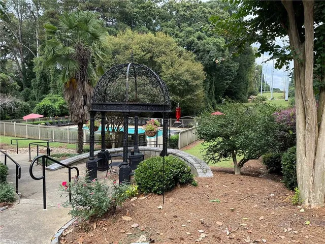 a view of a patio with chairs and floor to ceiling window