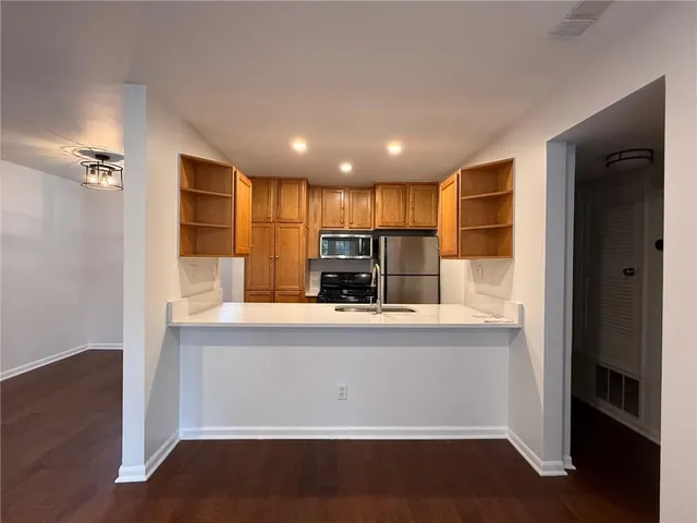 a kitchen with kitchen island a counter top space a sink and appliances