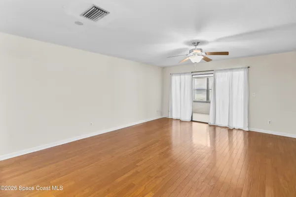 wooden floor in an empty room with a window
