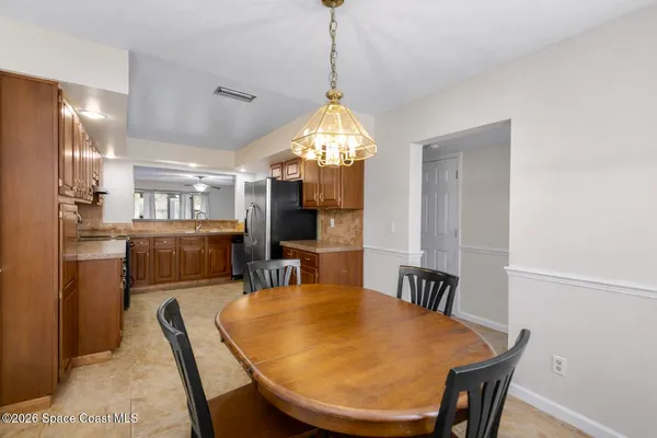 a kitchen with stainless steel appliances granite countertop a refrigerator a sink and wooden cabinets