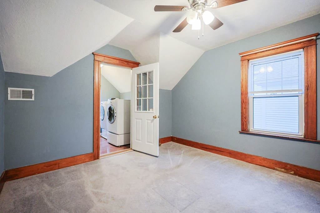 11 Hockanum Way Worcester, MA 01606 - Photo 24 of 36 an empty room with chandelier fan and windows