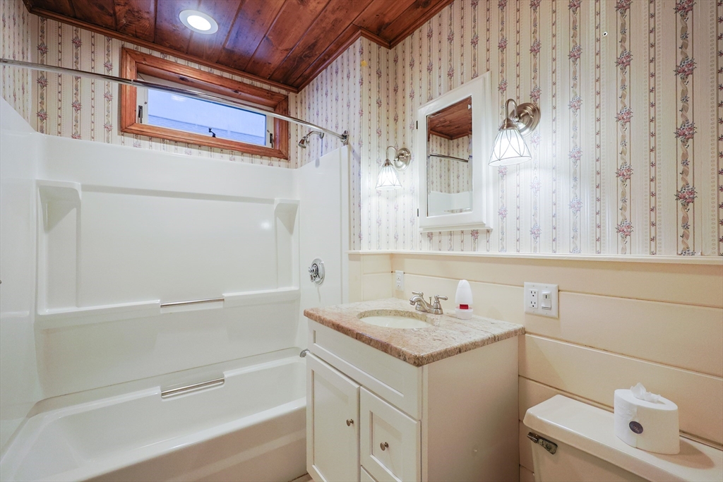 11 Hockanum Way Worcester, MA 01606 - Photo 26 of 36 a bathroom with a granite countertop sink toilet and mirror