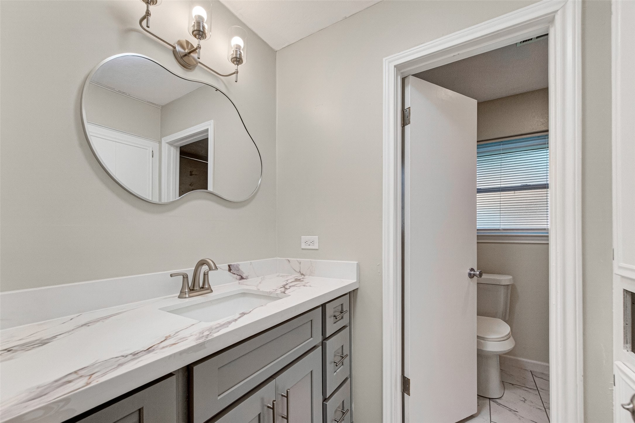 25503 Foxbriar Lane Spring, TX 77373 - Photo 28 of 45 a bathroom with a granite countertop sink a toilet and mirror