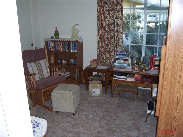 4413 Aquarius Road Lompoc, CA 93436 - Photo 15 of 19 a living room with furniture and a book shelf