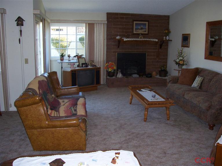 4413 Aquarius Road Lompoc, CA 93436 - Photo 16 of 19 a living room with furniture a fireplace and a large window