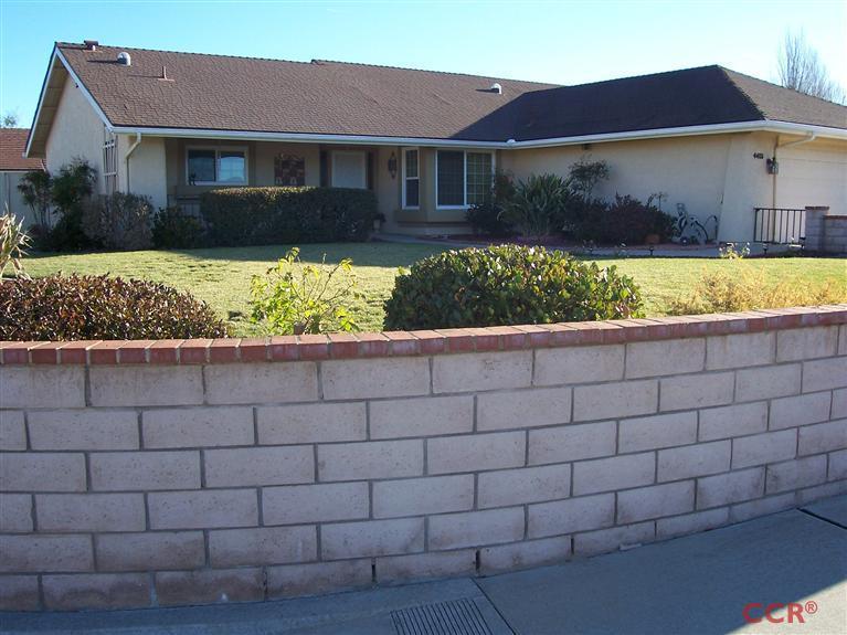 4413 Aquarius Road Lompoc, CA 93436 - Photo 2 of 19 a front view of a house with a yard and potted plants