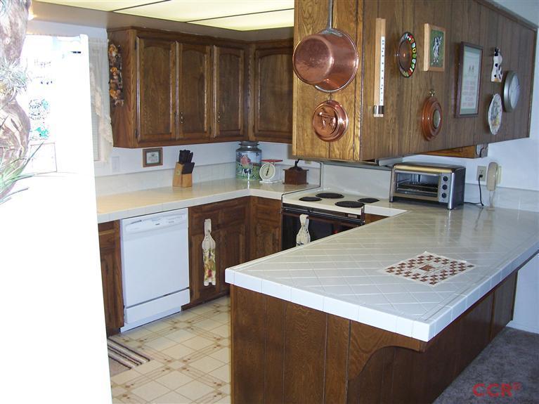4413 Aquarius Road Lompoc, CA 93436 - Photo 6 of 19 a kitchen with a sink cabinets and wooden floor
