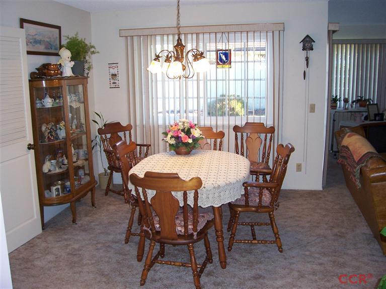 4413 Aquarius Road Lompoc, CA 93436 - Photo 8 of 19 a view of a dining room with furniture and chandelier