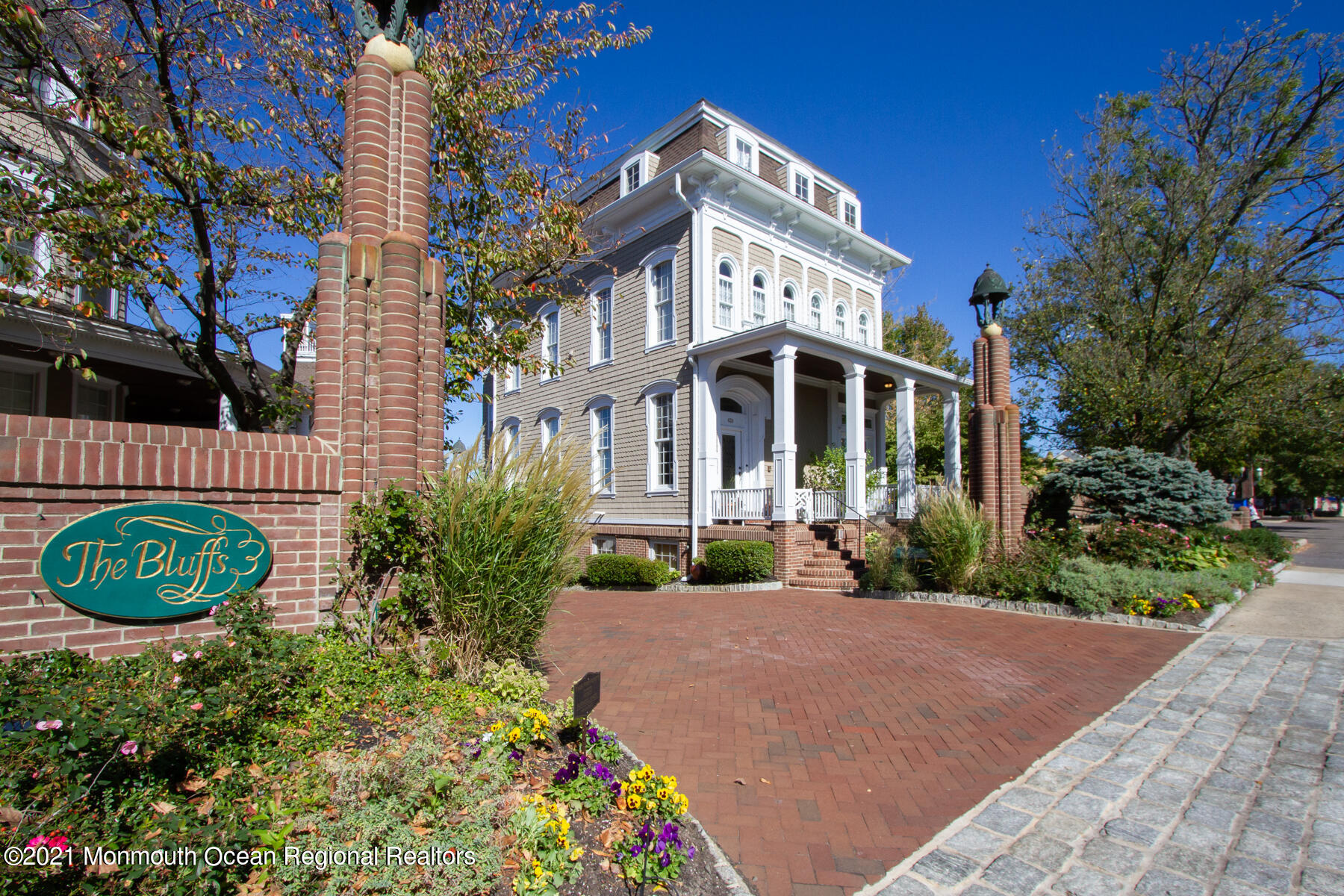 62 B West Front Street Red Bank, NJ 07701 - Photo 3 of 45 a view of a brick house with a flower garden in front of it