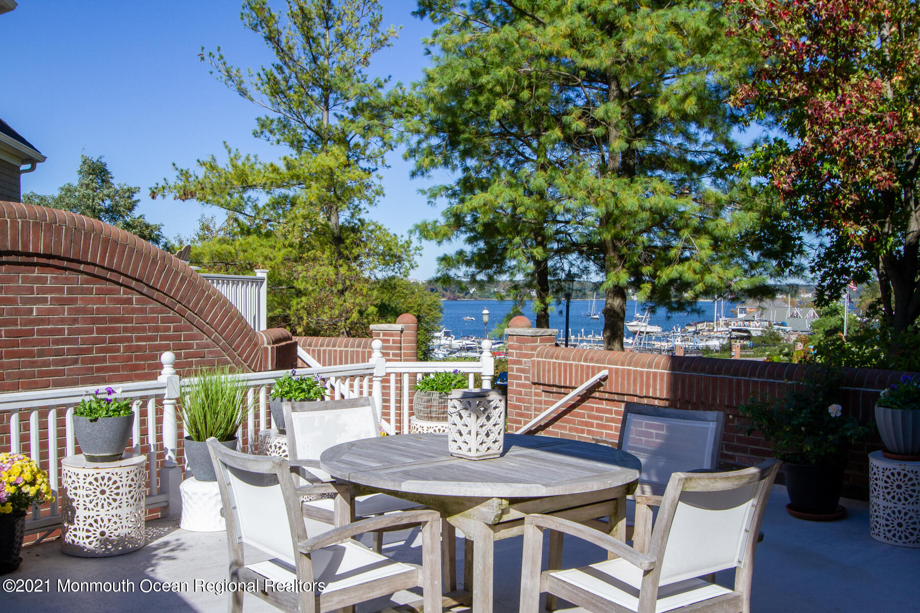 62 B West Front Street Red Bank, NJ 07701 - Photo 9 of 45 a view of a patio with table and chairs potted plants with wooden floor and fence