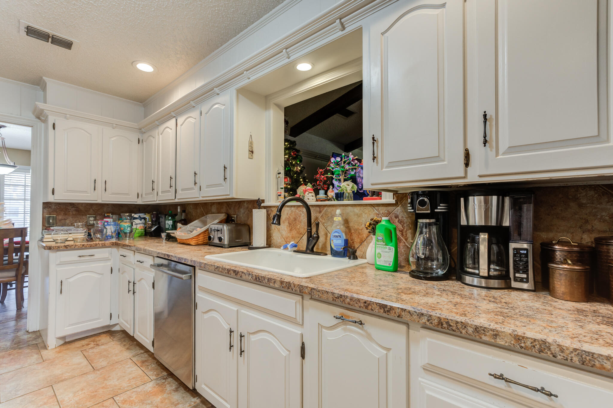5713 76th Street Lubbock, TX 79424 - Photo 13 of 62 a kitchen with stainless steel appliances granite countertop a sink a stove and cabinets