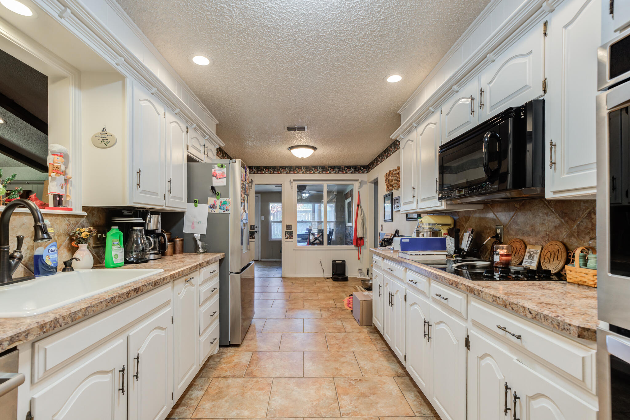 5713 76th Street Lubbock, TX 79424 - Photo 15 of 62 a open kitchen with stainless steel appliances granite countertop lots of counter top space