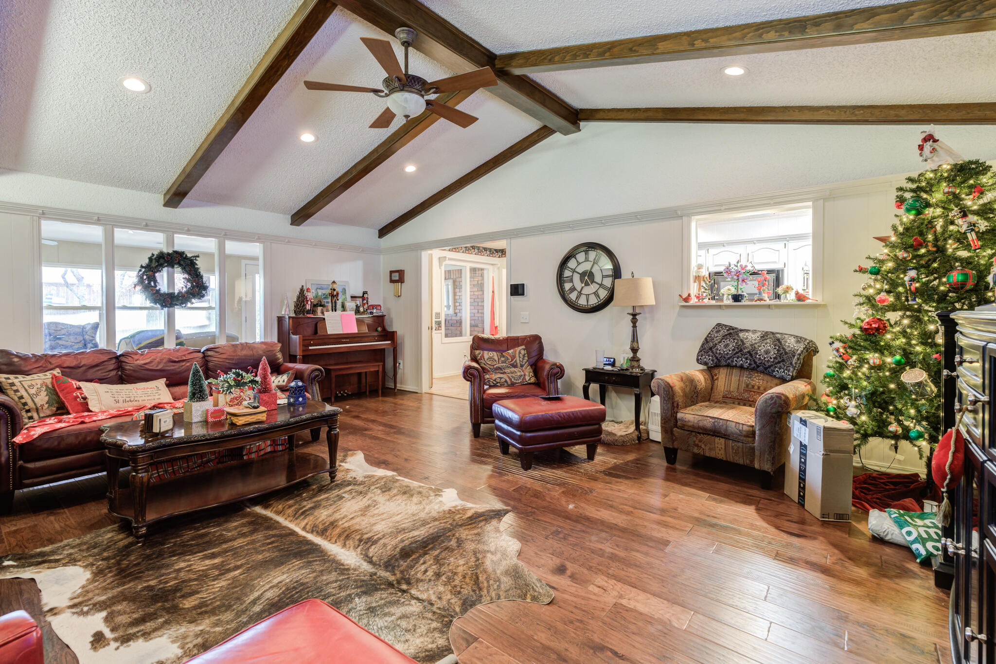 5713 76th Street Lubbock, TX 79424 - Photo 17 of 62 a living room with furniture a clock and a window