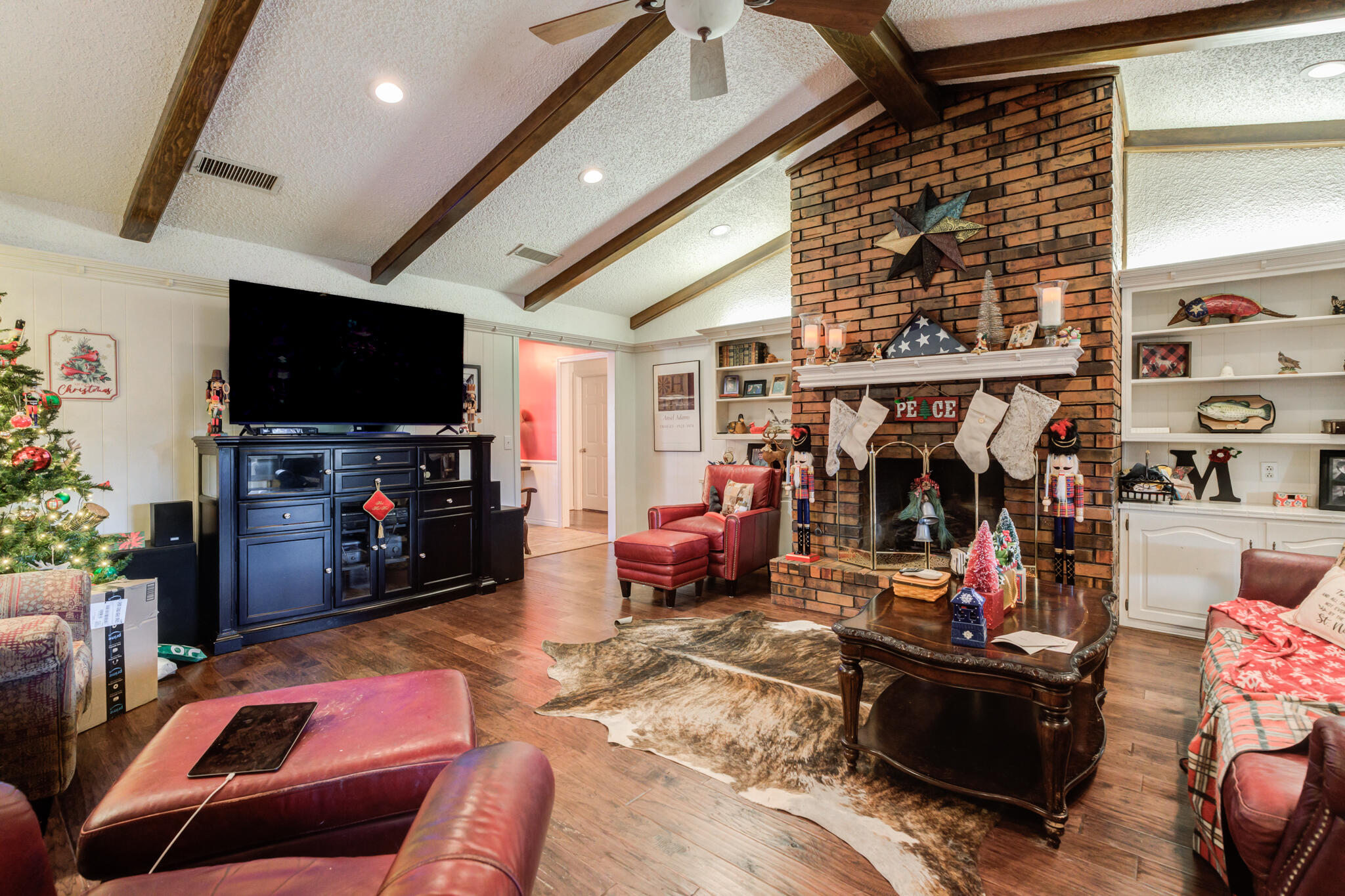 5713 76th Street Lubbock, TX 79424 - Photo 20 of 62 a living room with furniture and a flat screen tv