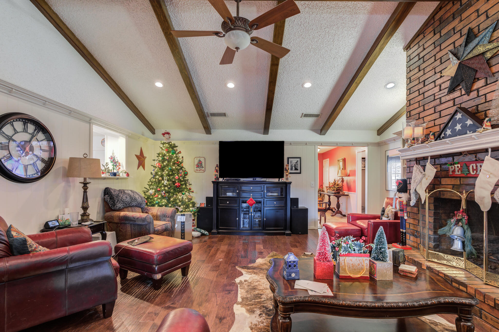 5713 76th Street Lubbock, TX 79424 - Photo 22 of 62 a living room with furniture and a flat screen tv
