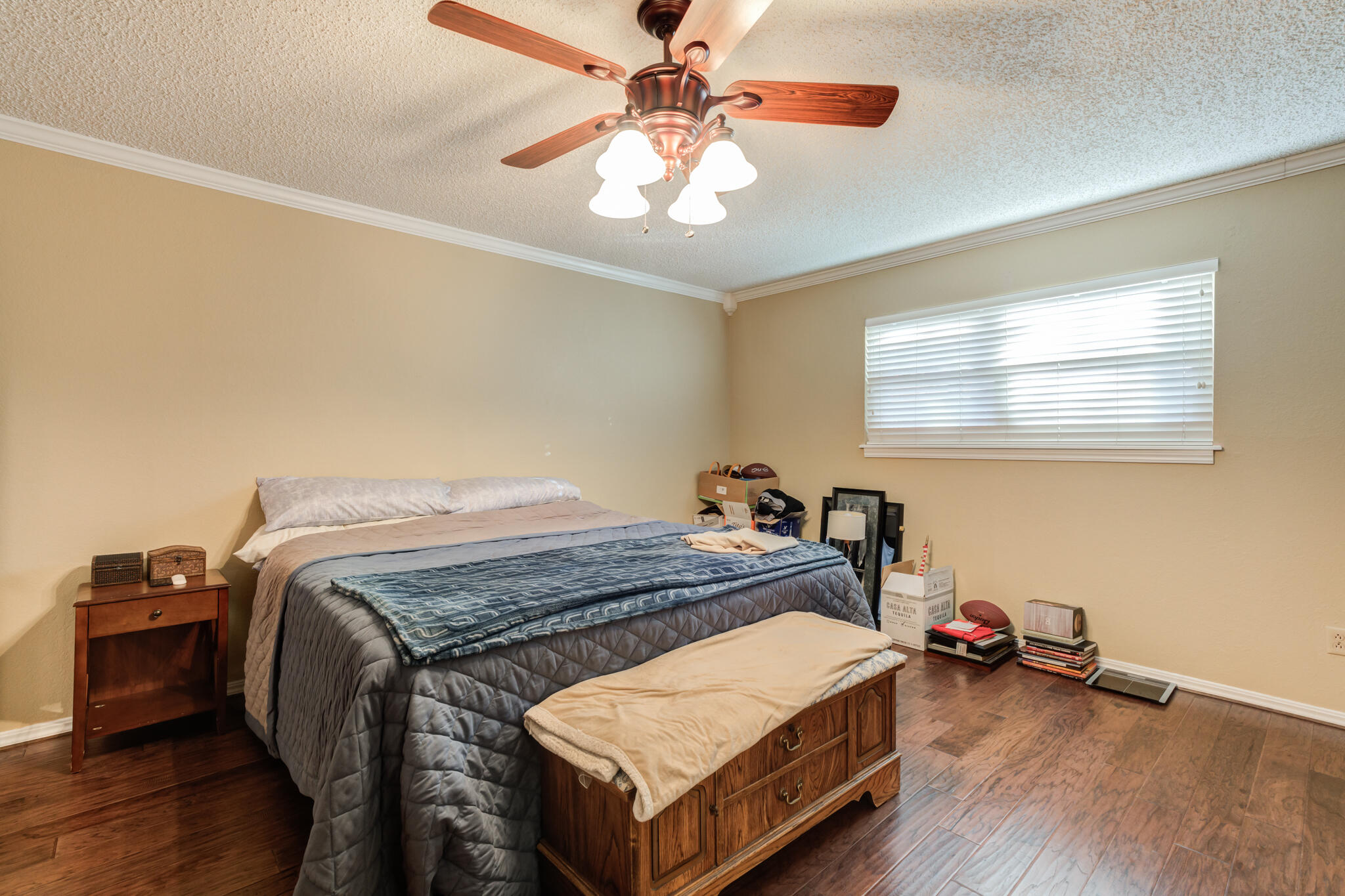 5713 76th Street Lubbock, TX 79424 - Photo 28 of 62 a bed room with a bed and a chandelier