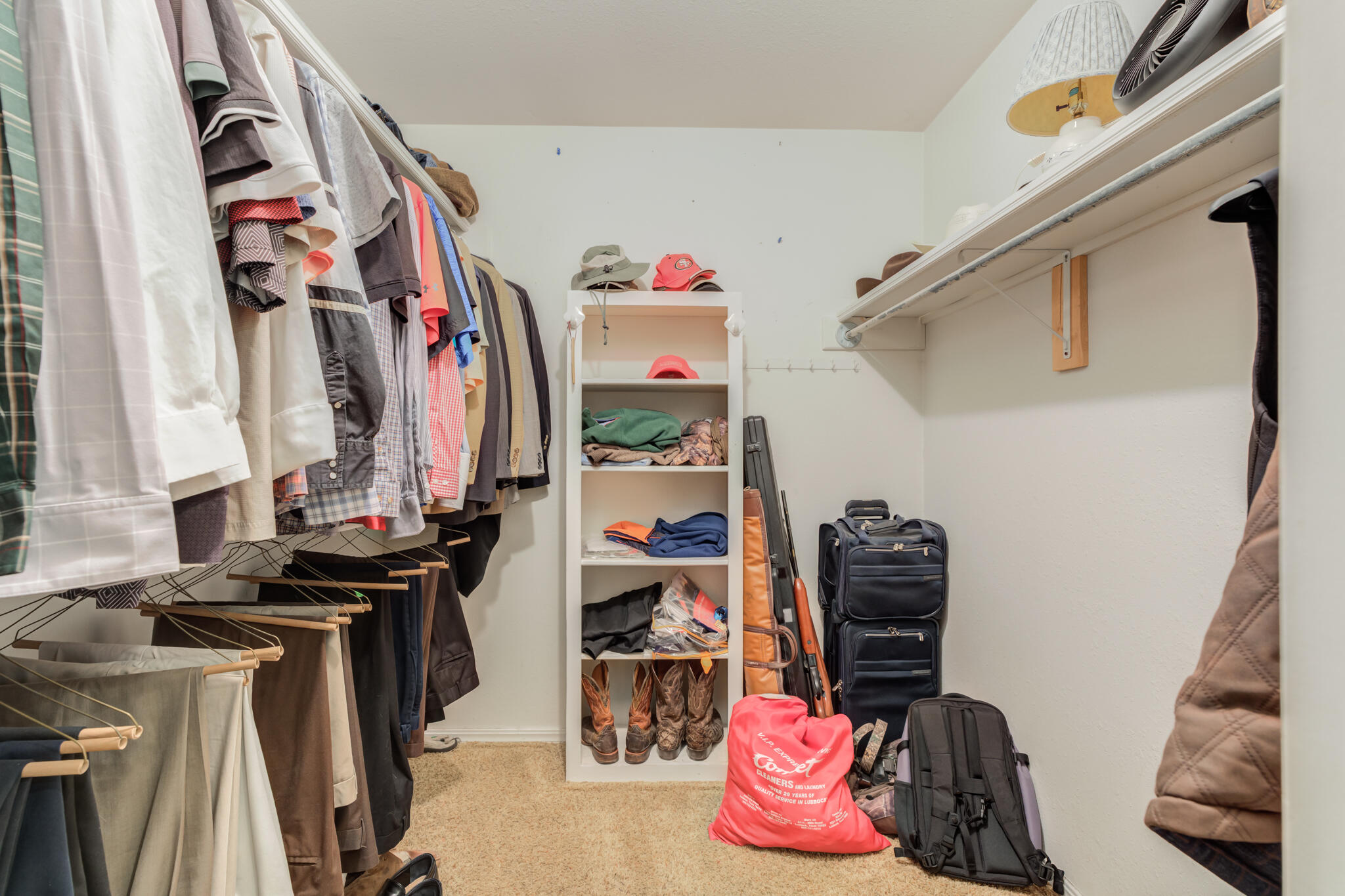5713 76th Street Lubbock, TX 79424 - Photo 30 of 62 a view of walk in closet with clothes and shoes