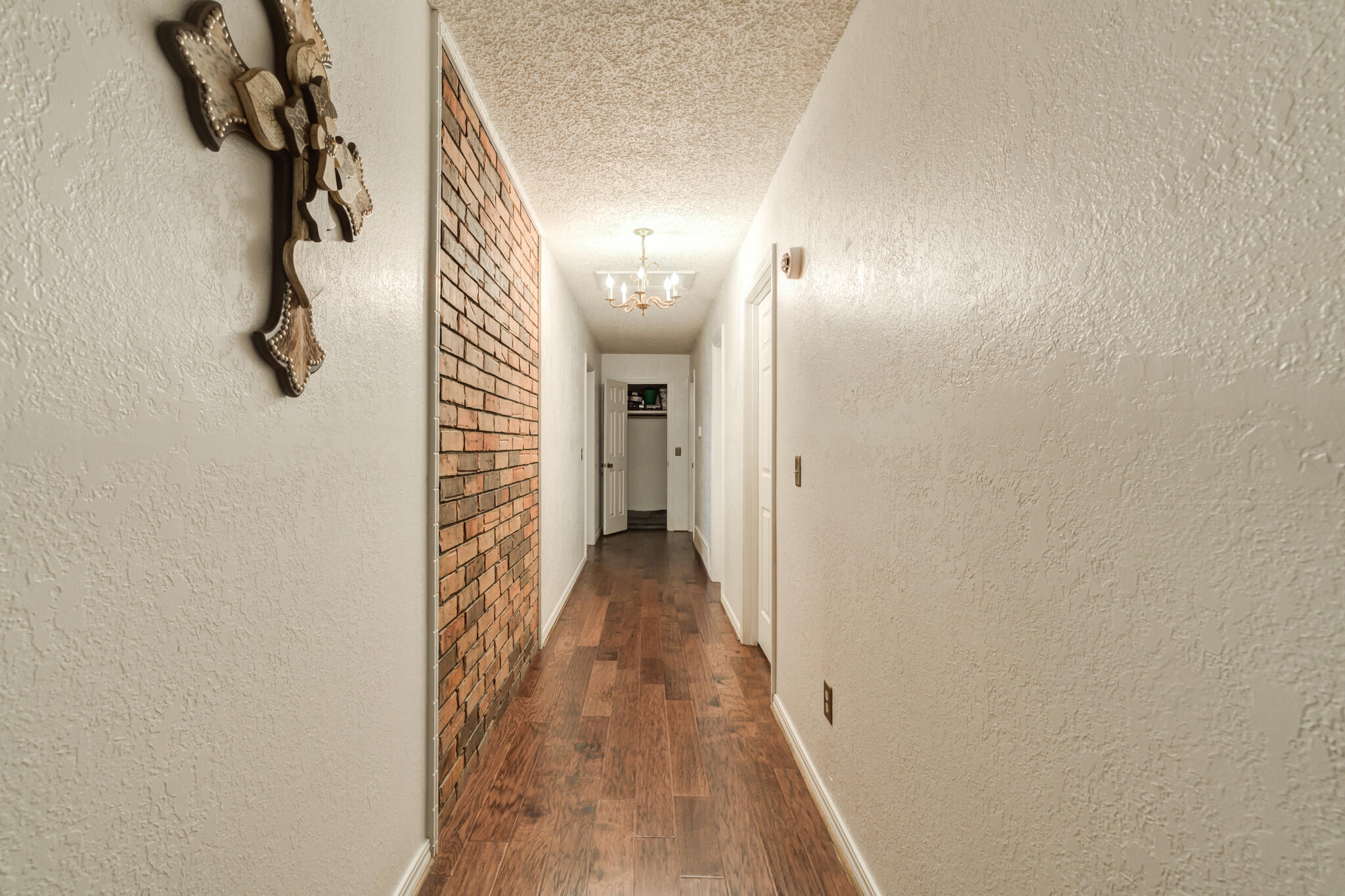 5713 76th Street Lubbock, TX 79424 - Photo 33 of 62 a view of a hallway with wooden floor and staircase