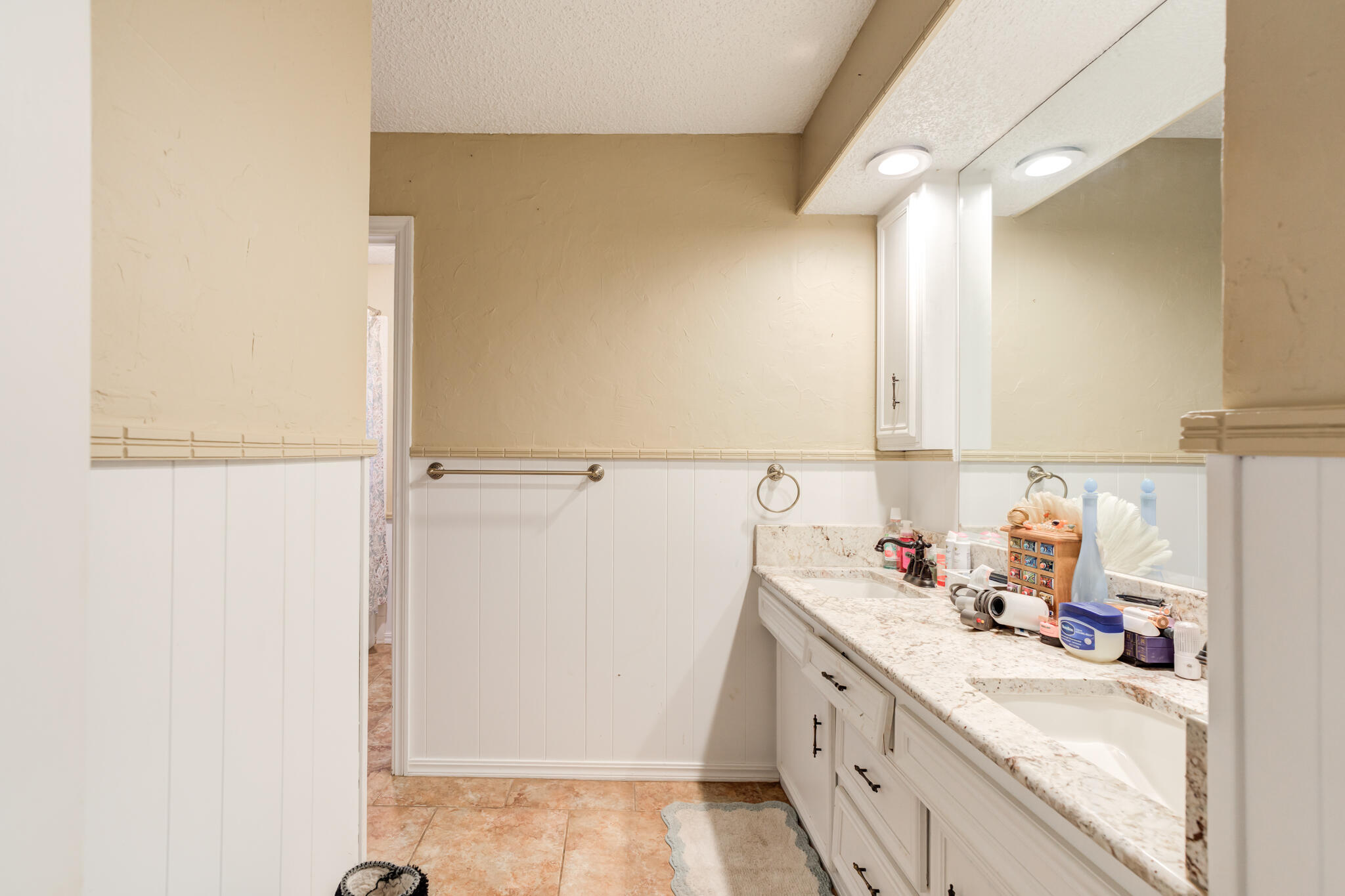 5713 76th Street Lubbock, TX 79424 - Photo 36 of 62 a kitchen with a sink a refrigerator and cabinets