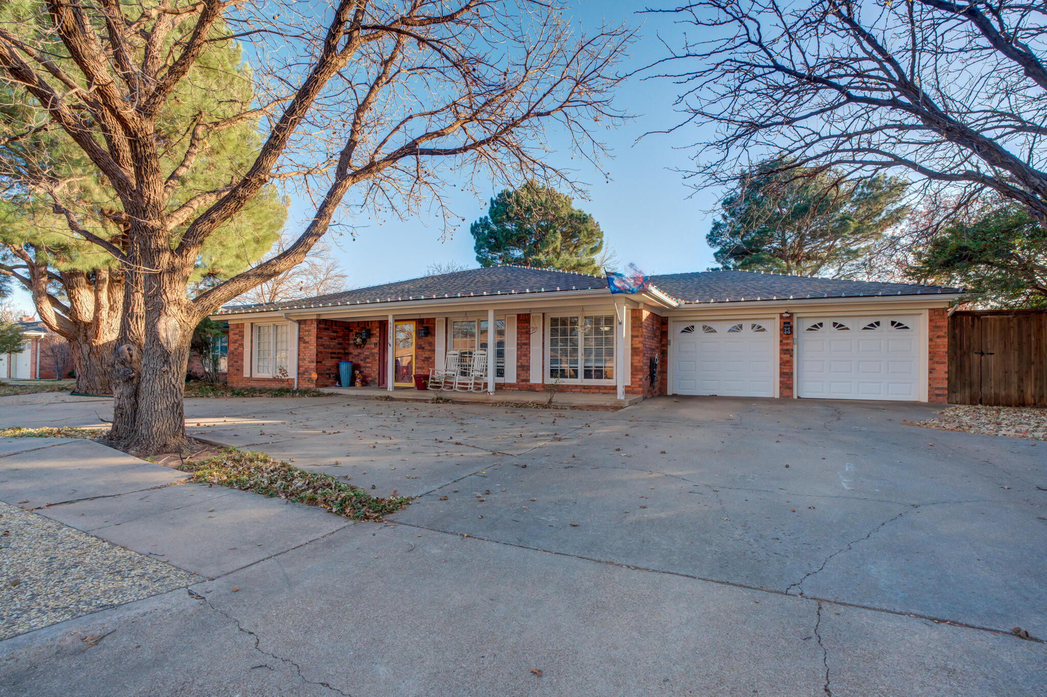 5713 76th Street Lubbock, TX 79424 - Photo 4 of 62 a view of a house with a tree in front of it