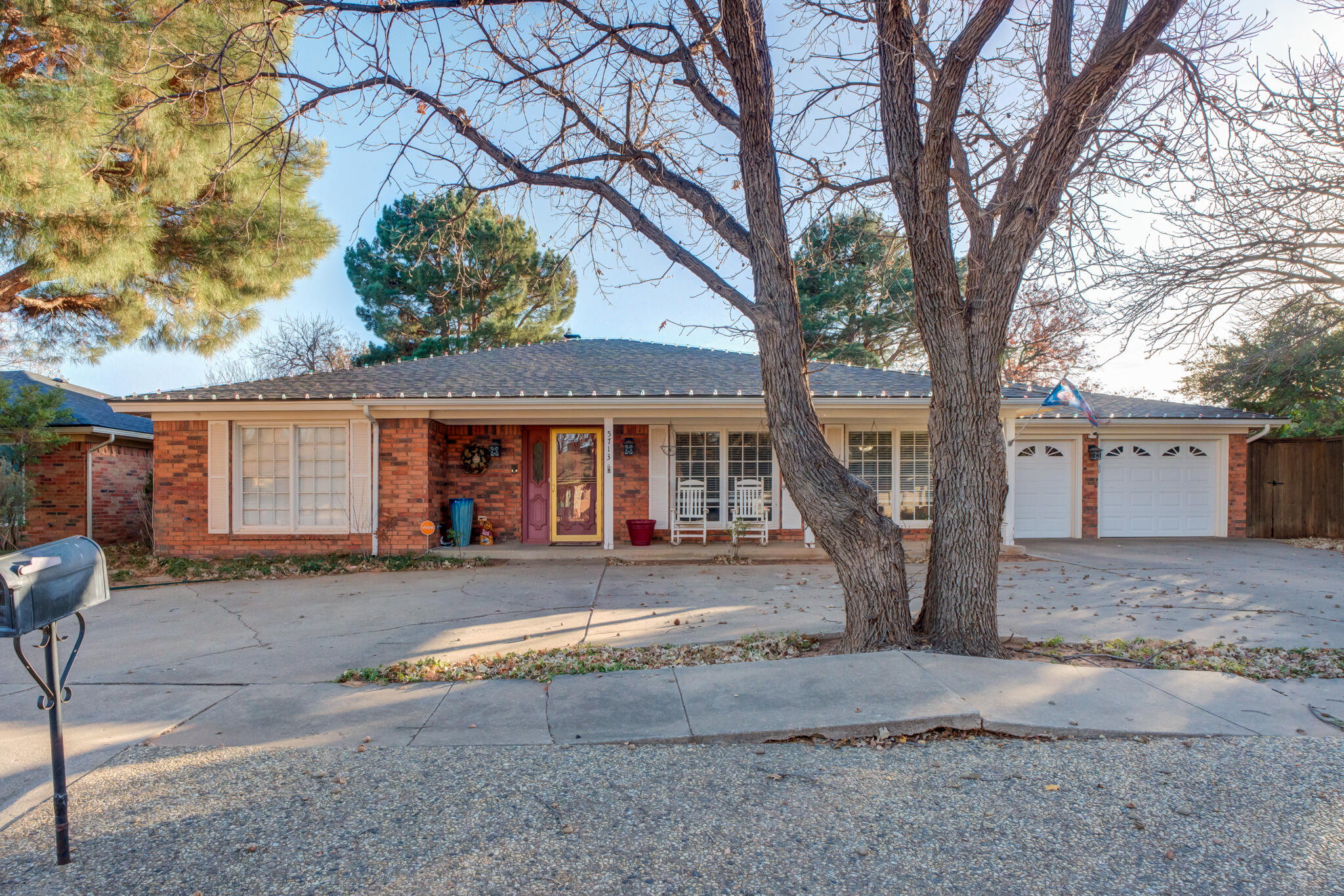 5713 76th Street Lubbock, TX 79424 - Photo 5 of 62 a front view of a house with a yard and garage