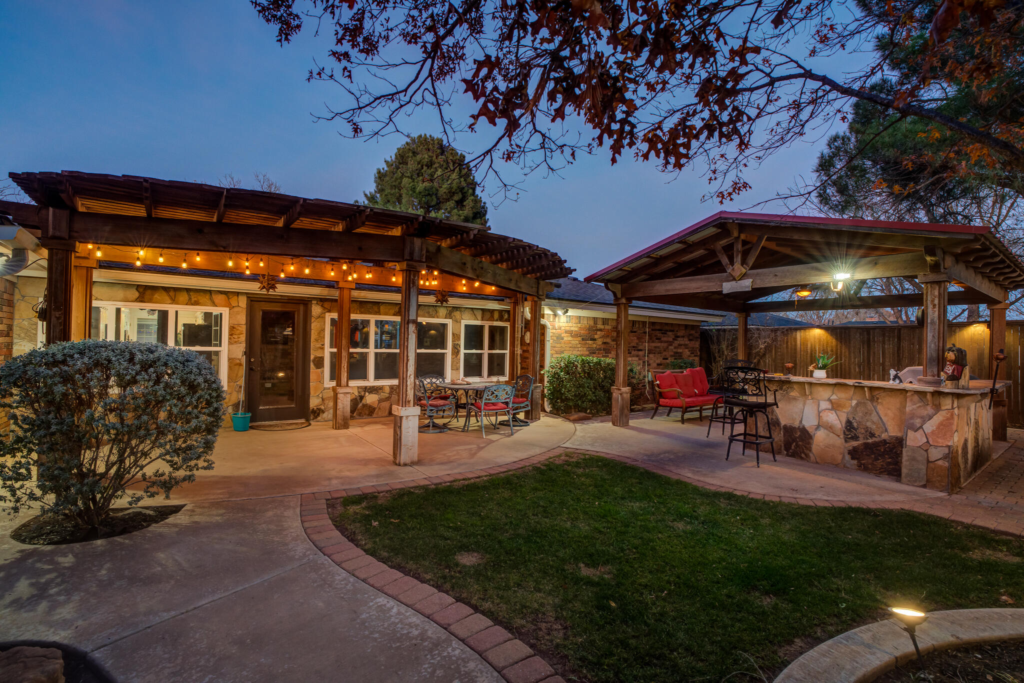 5713 76th Street Lubbock, TX 79424 - Photo 53 of 62 a view of a chairs and tables in patio and a small yard