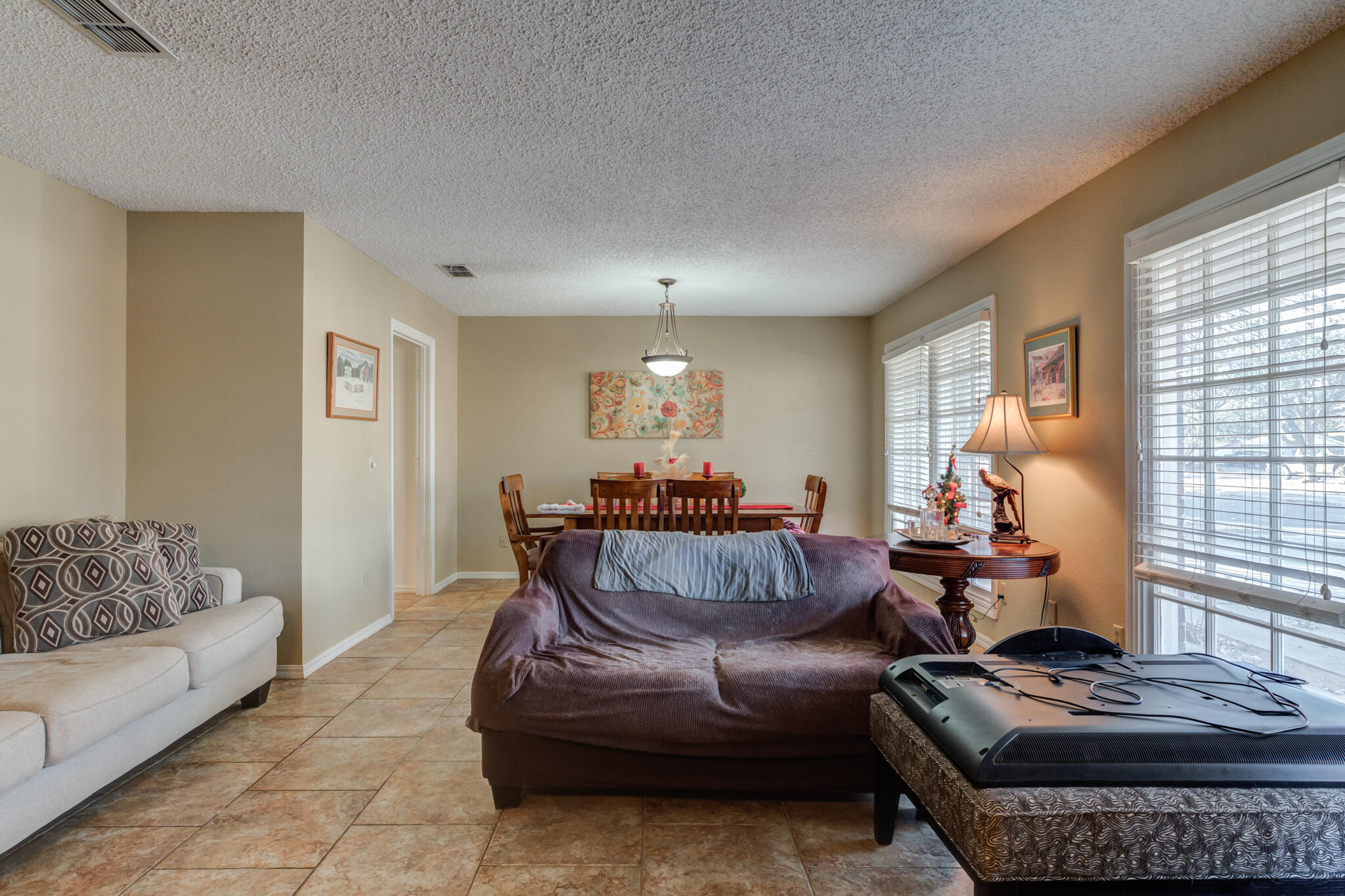 5713 76th Street Lubbock, TX 79424 - Photo 7 of 62 a living room with furniture and a window