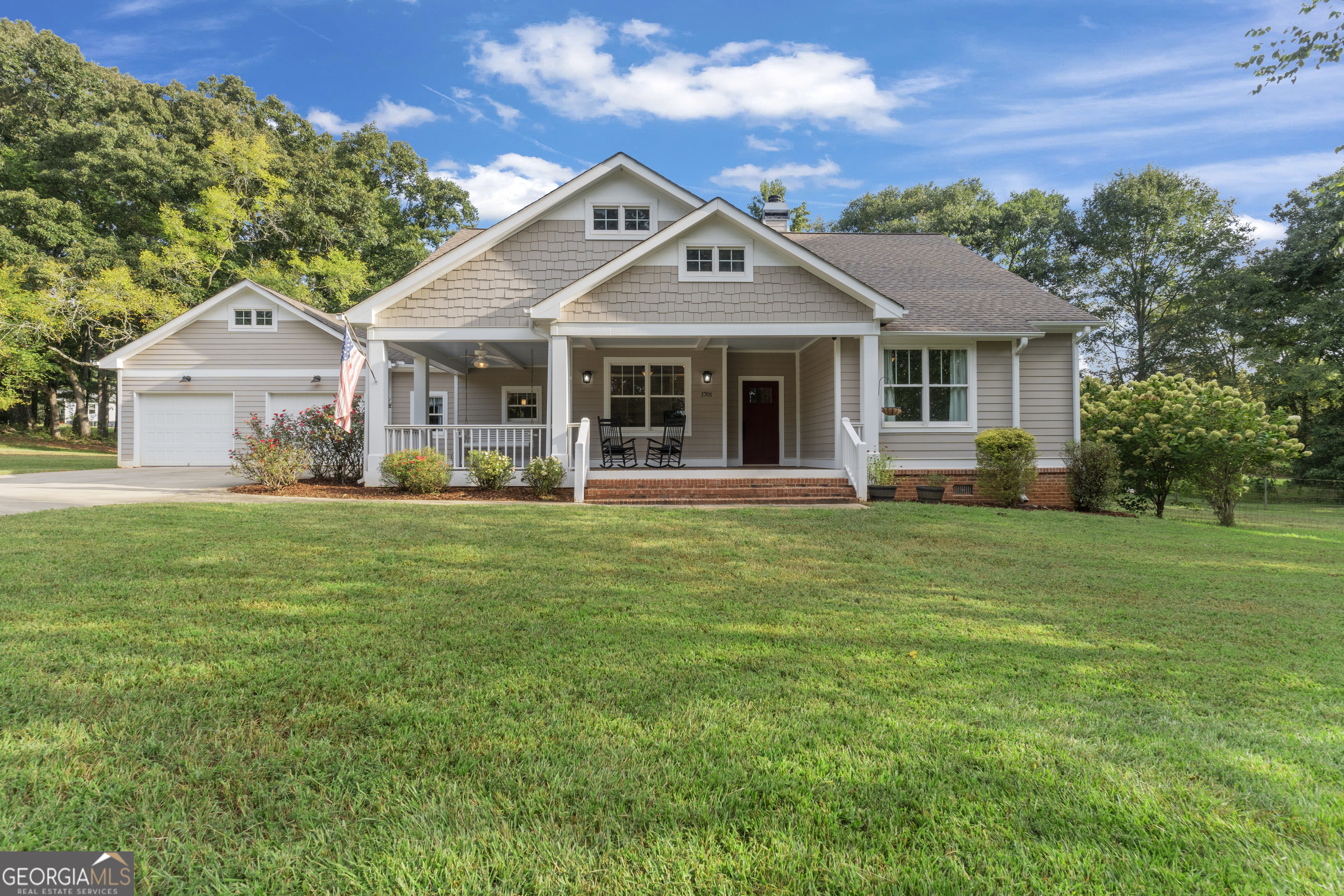 1701 Knight Road Rutledge, GA 30663 - Photo 1 of 1 a front view of a house with a garden and trees