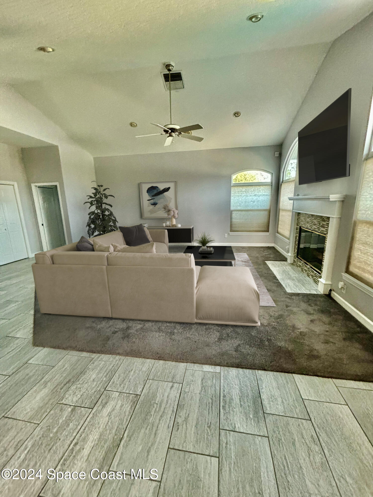 3455 Shady Run Road Melbourne, FL 32934 - Photo 6 of 47 a living room with a couch and a flat screen tv