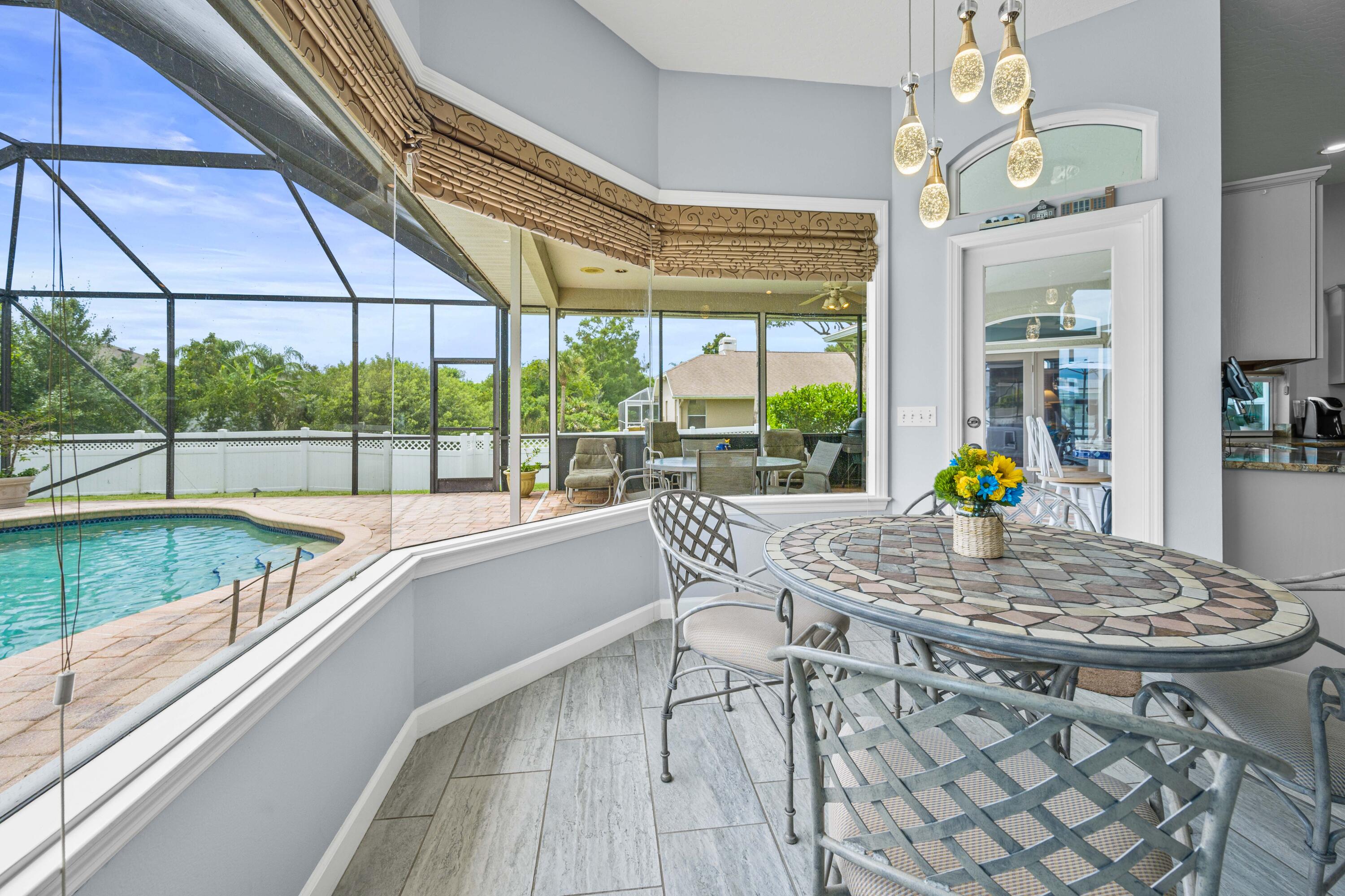 3455 Shady Run Road Melbourne, FL 32934 - Photo 10 of 47 a dining room with furniture and a floor to ceiling window