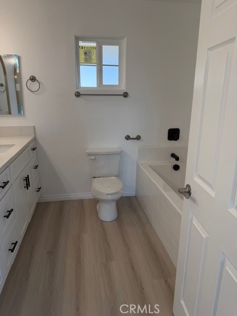 16925 Nanticoke Road Apple Valley, CA 92307 - Photo 31 of 87 a bathroom with a toilet a sink a mirror and vanity
