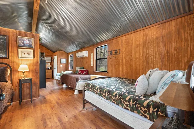 a living room filled with furniture hardwood floor and a ceiling fan